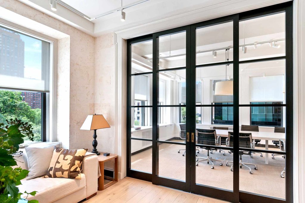 Ample natural light pours through two divided sections of an architect's office