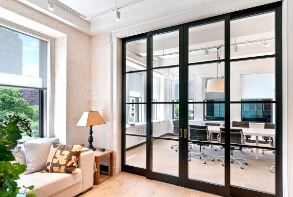 Ample natural light pours through two divided sections of an architect's office